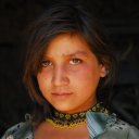 A necklace of black and yellow beads adorns this girl in northern Afghanistan. In a few short years she will not be able to run around this unencumbered in this conservative land