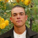 A teenage boy in a flower garden. At a young age Afghans cultivate a love for flowers; perhaps a reaction to the rugged land they live in