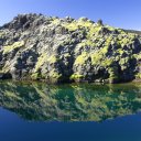 Crystal-clear-reflection-of-rock-and-sky-in-an-untouched-lake