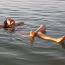 Woman-floating-happily-Dead-Sea