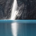 Waterfall plummeting into blue waters