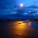 Eerie streetlight glow on wet pavement, Malmo