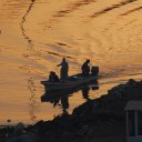 Fishermen getting ready by early morning light to set out to sea for another day\'s worth of work
