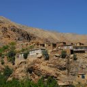 Settlements cling to cliffs near the treeline of the Hindukush Mountains