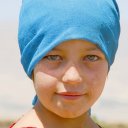 With sea green eyes and a confident face, this daughter of a nomadic tribe gazes into the camera lens