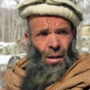 Deep lines have etched this man\'s face, testimony to the destruction of two decades of war he has suffered under