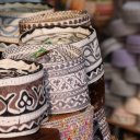 Hats lined up outside large mosque