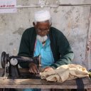 Old man sewing, on the streets of Dhaka