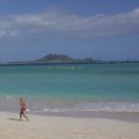 Scantily clad woman walking one of Oahu\'s north shore beaches