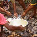 Removing the food from the ground after cooking all morning - traditional mumu