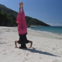 Woman doing headstand, near White Beach