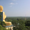 Golden Buddha overlooking the vast green jungle - Dambulla