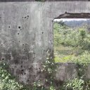 Bullet holes in a shell of a building, left over from the 30+ year old war