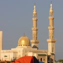 Tall minarets rise above the dome of a mosque in officially Islamic Dubai