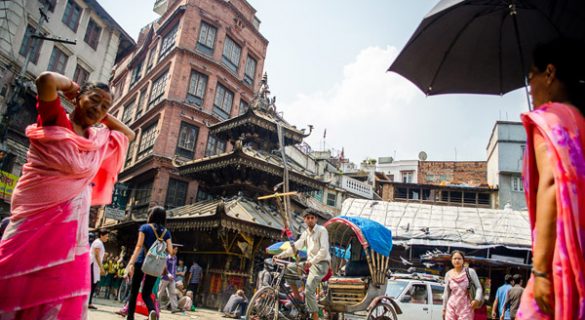 A rickshaw driving through an intersection in Kathmandu, Nepal