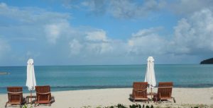 Loungers on beach of Hermitage Bay in Antigua