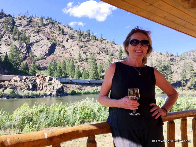 Sweeney enjoying a glass of wine on the porch of a cabin at Quinn's Hot Springs Resort in Paradise, Montana