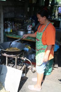Happily cooking in a narrow alleyway in Klong Toey