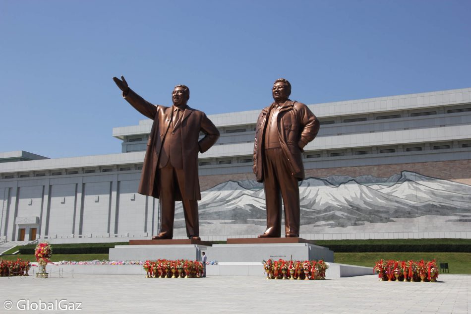 The former leaders (Kim Jong-il and Kim Il-sung) of North Korea greet visitors to their country.
