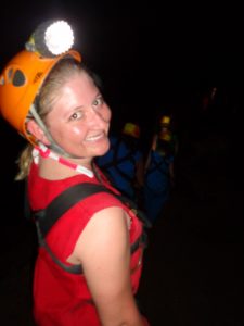 Girl with headlamp on in cave