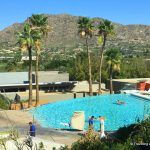 Infinity-edge pool with vistas of Mummy Mountain and mountainside homes of Paradise Valley