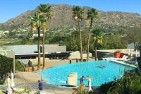 Infinity-edge pool with vistas of Mummy Mountain and mountainside homes of Paradise Valley