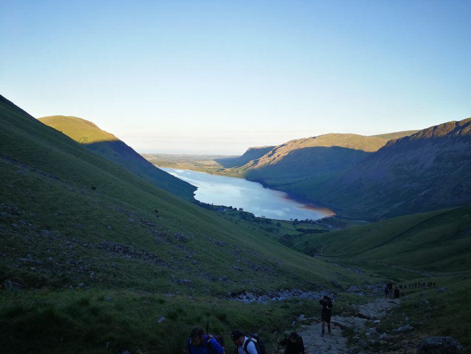 Looking back towards Wast Water as the sun rises hiking up Scafell Pike