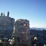 Busy summit cairn at the top of Scafell Pike