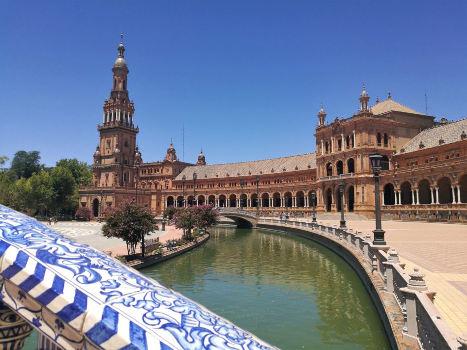 A view from an ornate bridge onto Plaza de Espana in Seville, Spain
