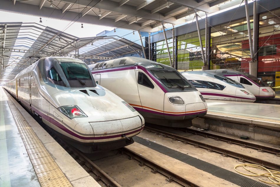 3 different trains parked up at a train station in Spain