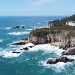 Aerial view of Cape Ashizuri's dramatic sea cliffs and lighthouse on Shikoku's southern coast, Kochi, Japan