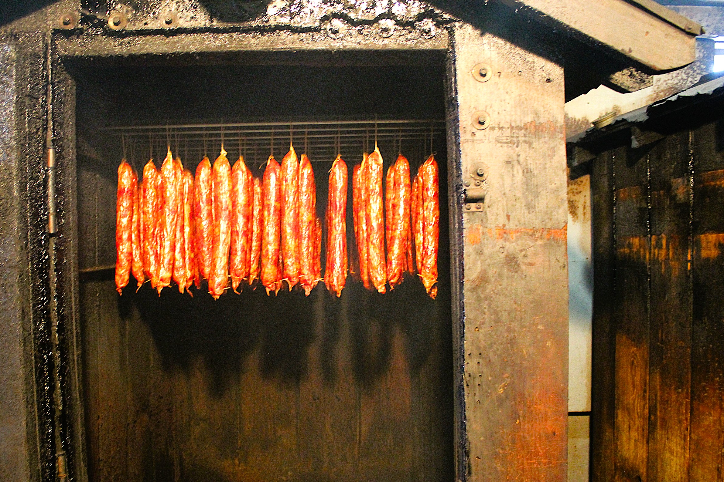 Smokehouse holds multiple links of freshly smoked andouille
