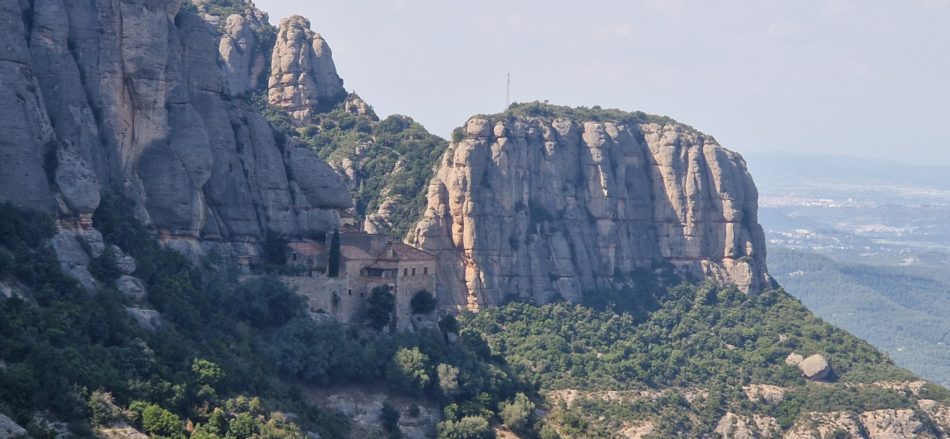 The Santa Cova chapel of Montserrat set against the rock cliffs, seen from the Camí de la Santa Cova