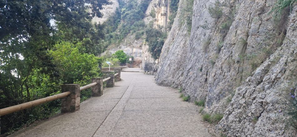 The final stretch of the Camí de la Santa Cova path carved into the rock, leading to the Santa Cova chapel