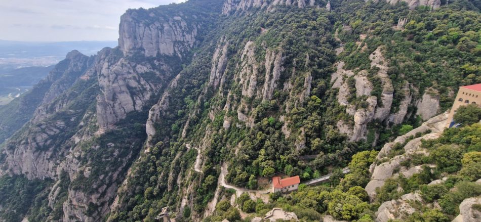 The Camí de la Santa Cova path descending through the Montserrat mountain toward the chapel, seen from the monastery