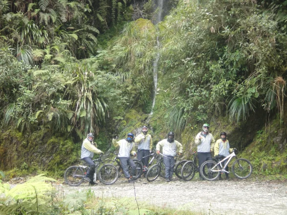 Group under waterfall on death road