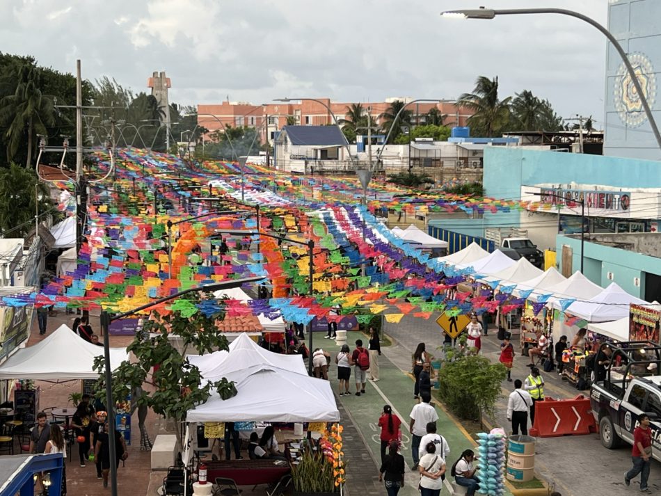 Puerto Juárez street covered with colorful papel picado during the Hanal Pixán festival in Cancun.